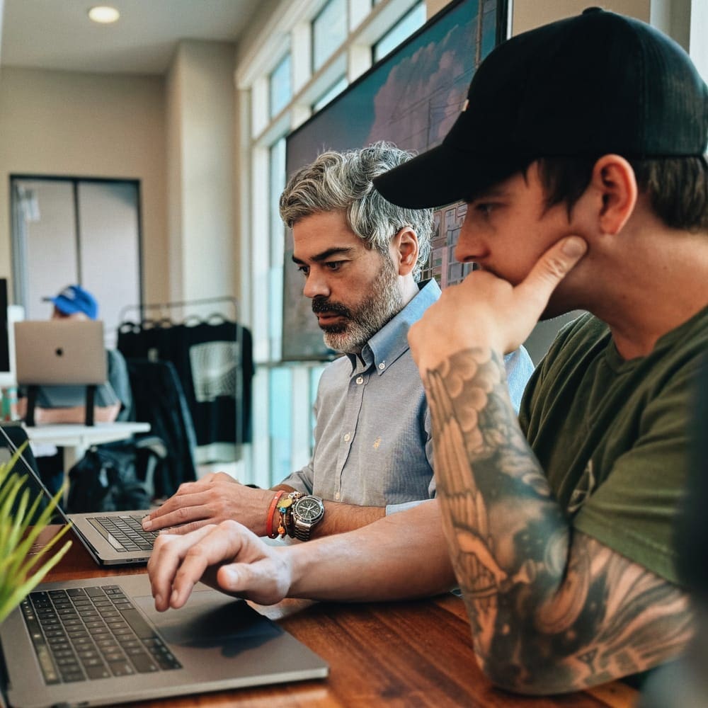 Jeremy Meindl working with Brain on their laptops